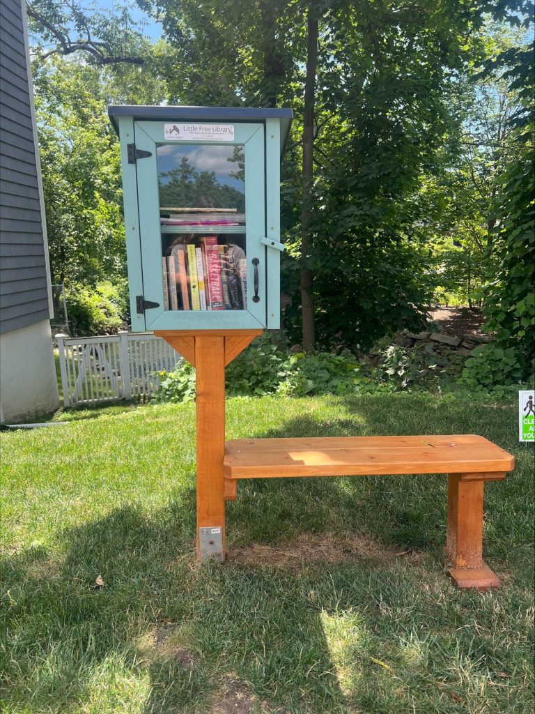 Books in a box near a bench